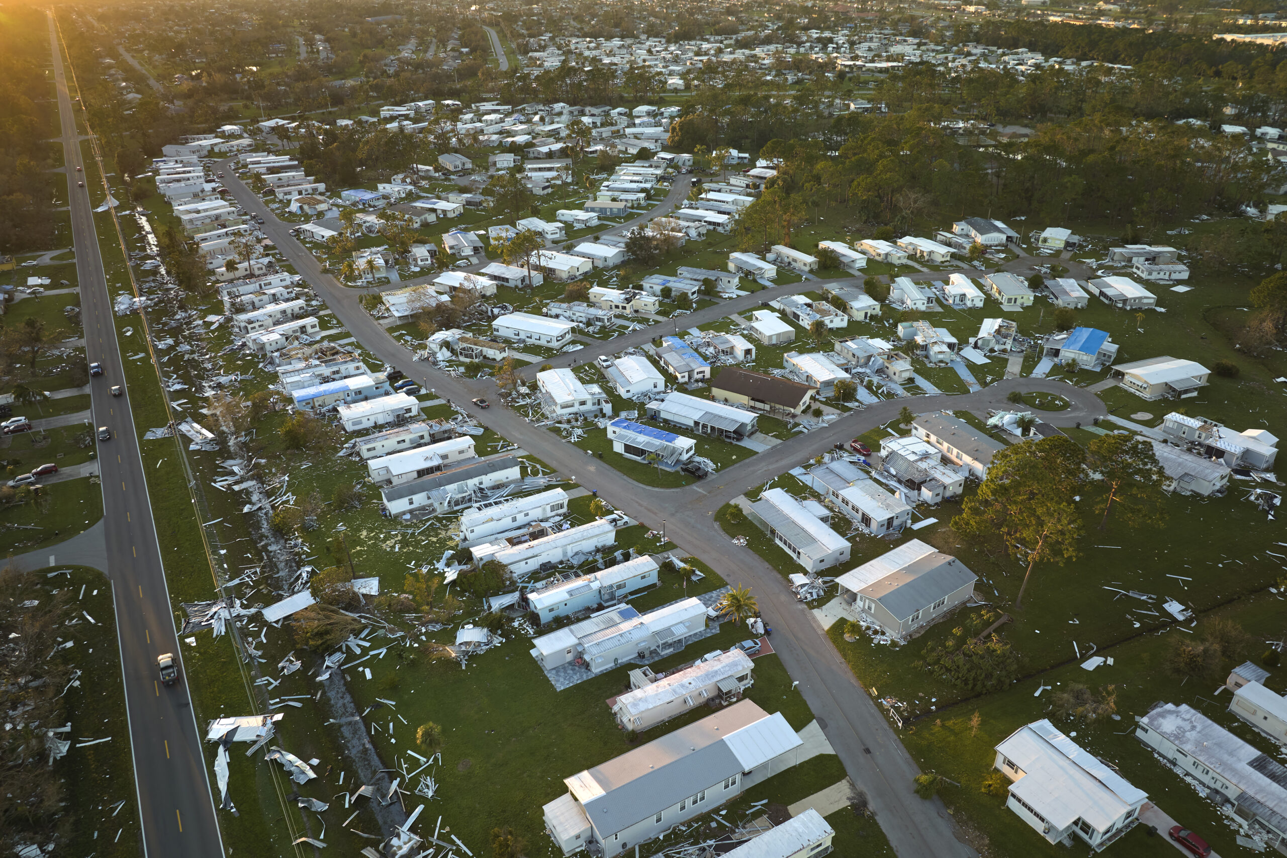 Severely damaged houses after hurricane Ian in Florida mobile home residential area.